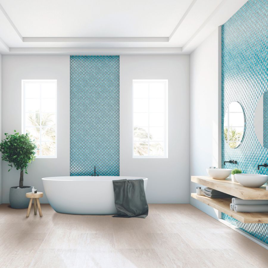Modern bathroom with a white oval bathtub, turquoise mosaic tile accent wall, floating wooden vanity, and natural light from tall windows.